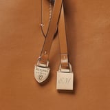Zipped East West Tote with Shield Charm Smooth Tan