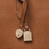 Zipped East West Tote with Shield Charm Tan Pebble
