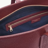 Zipped East West Tote with Shield Charm Garnet Pebble