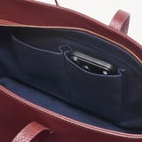 Zipped East West Tote with Shield Charm Garnet Pebble