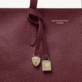 Zipped East West Tote with Shield Charm Garnet Pebble