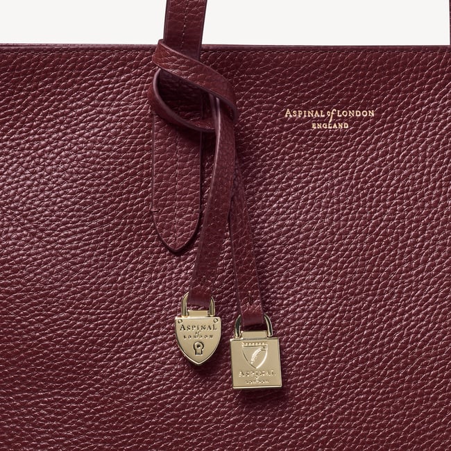 Zipped East West Tote with Shield Charm Garnet Pebble