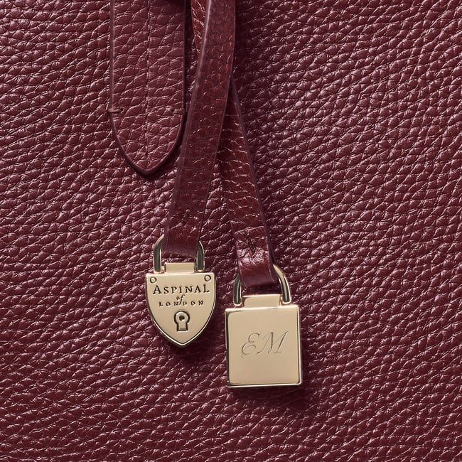 Zipped East West Tote with Shield Charm Garnet Pebble