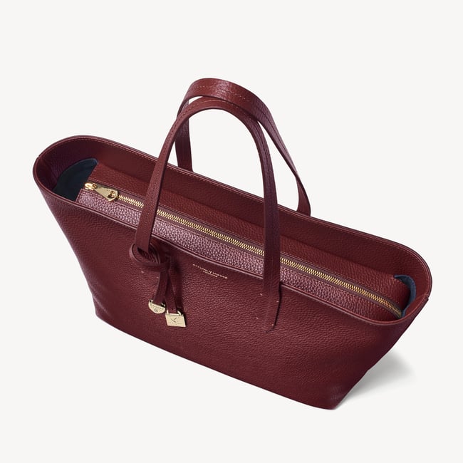 Zipped East West Tote with Shield Charm Garnet Pebble