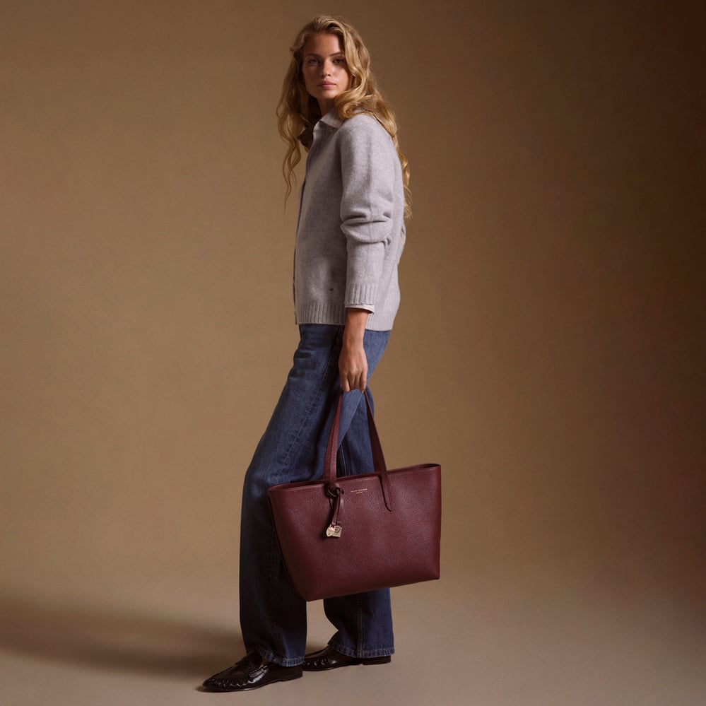 Zipped East West Tote with Shield Charm Garnet Pebble