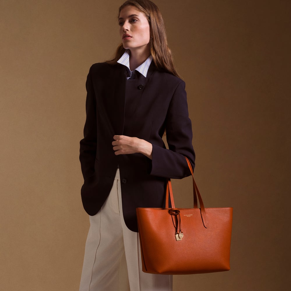 Zipped East West Tote with Shield Charm Marmalade Pebble